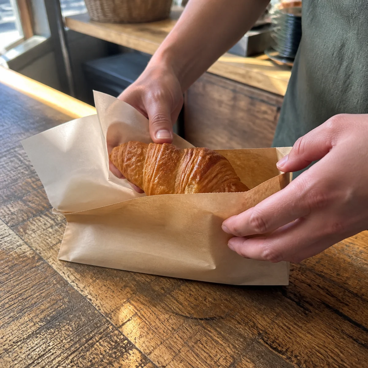AI-generated concept photograph of hands packaging a café takeaway order